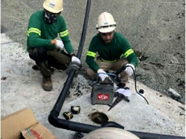 Technicians assembling HDPE pipework for a submersible pump installation